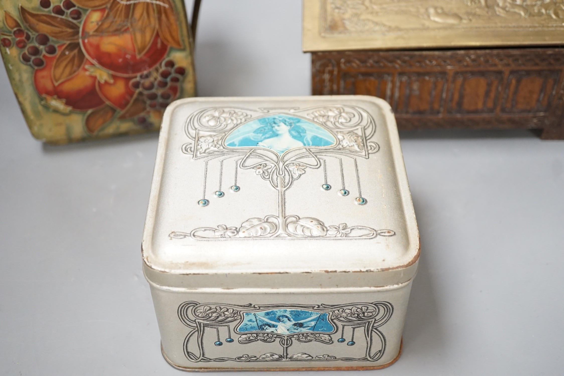 A Jacobs embossed coffer shaped biscuit tin, 16cm wide, a Pomegranate design tin after Moorcroft and one other biscuit tin, (3)